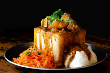 A Durban Bunny Chow - or quarter mutton bunny - served with sambals. This is an iconic Durban meal consisting of a section of a loaf of bread hollowed out and filled with mutton curry and gravy.