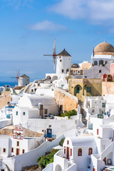 Traditional whitewashed architecture and windmills in Oia. Santorini, Greece
