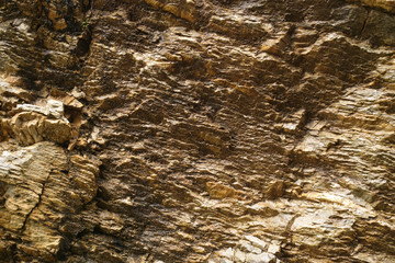 Abstract background with golden color mineral rock texture close up