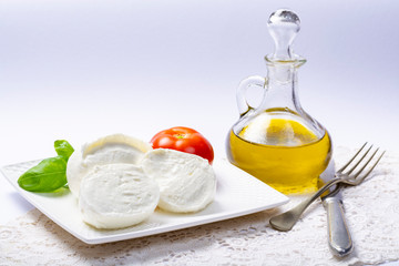 Soft white Italian cheese Mozzarella buffalo served with fresh tomato, olive oil and green basil leaves