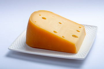 One piece of traditional Dutch old hard cheese made from cow milk