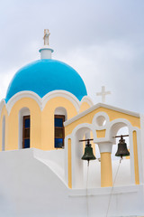 Fototapeta na wymiar Blue dome of a traditional church in Fira, Santorini, Greece