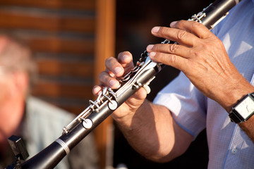 man playing clarinet on street