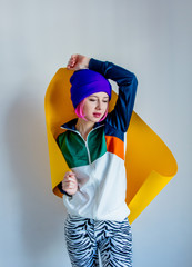 Young girl in 90s style jacket wrap up; with yellow paper