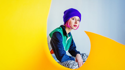 Young girl in 90s style jacket and twist yellow paper