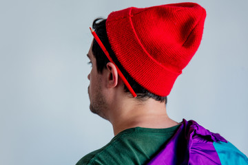 Style man in red hat and trendy clothes with pencil on ear.
