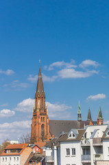 Fototapeta na wymiar Tower of the St. Pauls church and houses in Schwerin, Germany