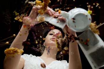 Young woman preparing herbal tea in a sachets.