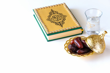 Organic dried dates traditional arabic golden plate, cup pure drinking water and quran book....