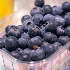 Big fresh ripe organic natural blueberry in package on the showplace in the market