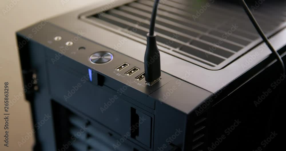 Poster man struggles to plug cable into usb 3.0 port on desktop computer