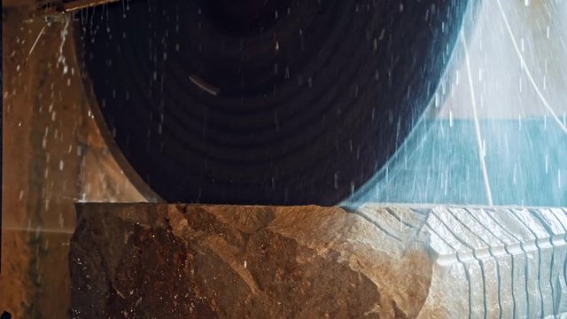 Industrial factory of marble manufacture. Industrial technical equipment cutting with electric saw during align marble tiles at construction site
