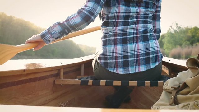 Close up of woman paddling canoe on the lake