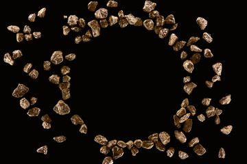 top view of round frame made of gold stones isolated on black with copy space