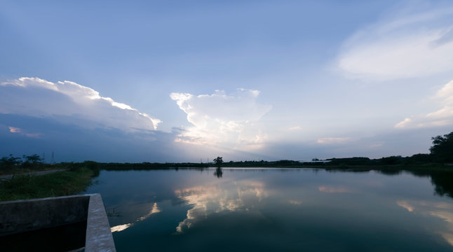 cloud in blue sky and reflex on water 