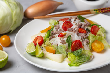 Spicy Thai salad with ground beef and rice noodles