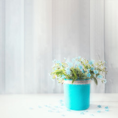 bouquet of blue forget-me-nots on the table. background with spring flowers.