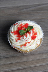 Red velvet cupcake. The finished cakes are on the table. Decorated with mint leaves.