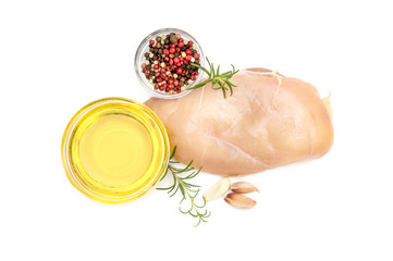 Raw chicken fillet with spices and cooking oil on white. Top view.