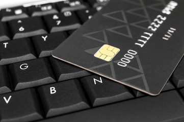 Credit card on the laptop keyboard. Close up.