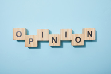 top view of wooden cubes with letters on blue surface