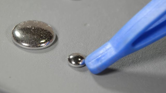 Drops of Mercury (Hg) are being pushed around and merge.