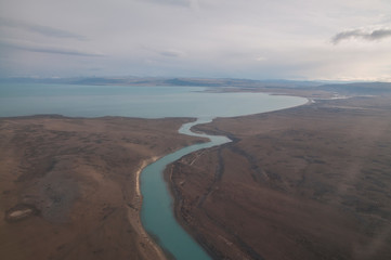 Fototapeta na wymiar Santa Cruz River's mouth to Lago Argentino, as seen from a plane approaching El Calafate Airport, Santa Cruz, Argentina.