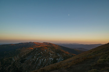 A little snow and moon above mountains sunset - landscape of the Ukrainian Carpathian Mountains, Chornohora