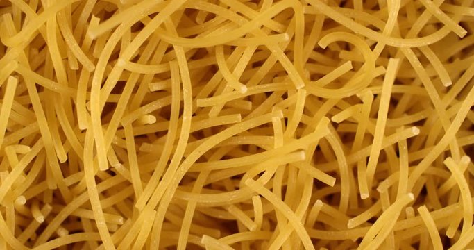 Vermicelli angel hair soup pasta rotating in slow motion. Extreme close up top view, shot on RED 6K camera