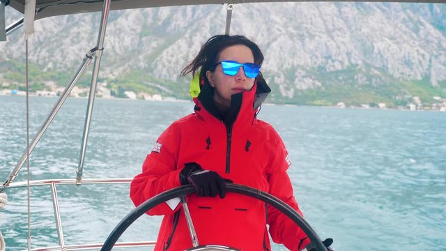 Yacht is being managed by a woman in an anorak