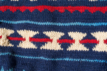 Obraz premium Knitted texture with blue pattern close up