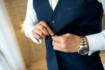 business man button his jacket. Man getting ready for work.