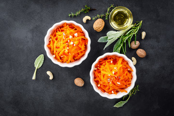 Fresh carrot salad with oil and nuts