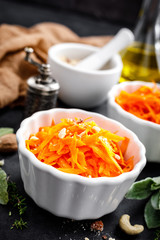 Fresh carrot salad with oil and nuts