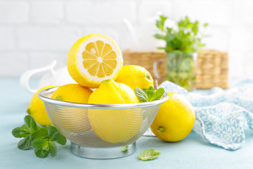 Sliced and whole lemons with mint