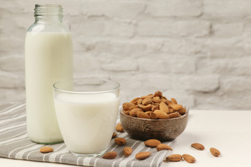 Obraz na płótnie Canvas Almond milk and nuts. Organic vegan non-dairy plant-based milk in a glass.