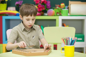 A child with a musical instrument. Boy learn to play dulcimer