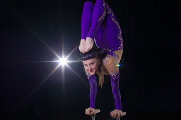 Circus actress performs the number in a beautiful smoke. Manual equilibrium on canes. Flexible girl...