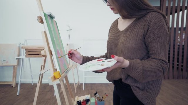Girl artist paints picture