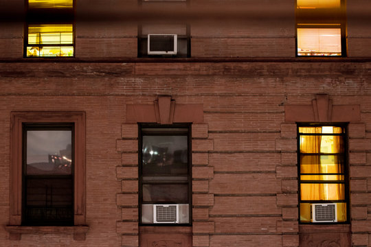 Facade Of A Typical Brownstone Apartment Building At Night, Harlem, New York City, NY, USA