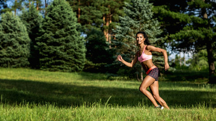 Obraz na płótnie Canvas Young female runner jogging during outdoor workout in a park. Beautiful fit girl. Weight Loss. Sport LIfestyle.