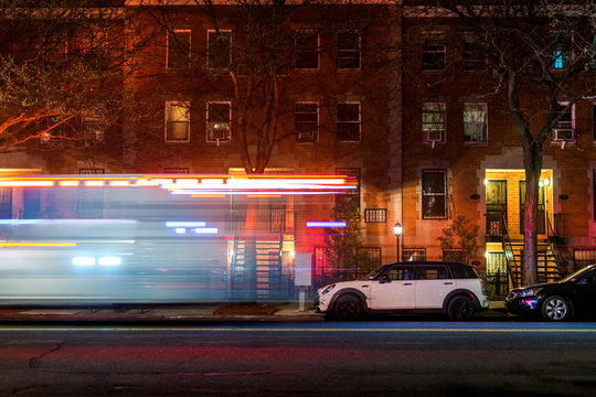 Lightstreaks From A New York City Firetruck Or Ambulance Speeding Down An Empty Harlem Street Late At Night