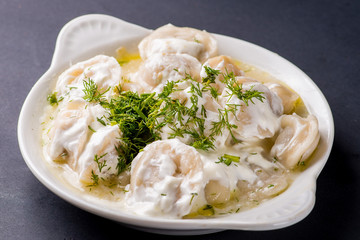 boiled dumplings with filling and sauce on the plate.