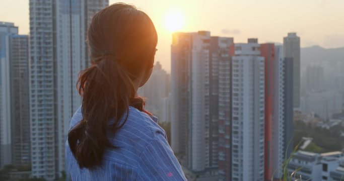 Woman enjoy the sunset view in city