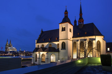 a church and the dom of cologne at night