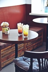 Two glasses of iced lemonade on the coffee shop background