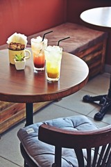 Two glasses of iced lemonade on the coffee shop background