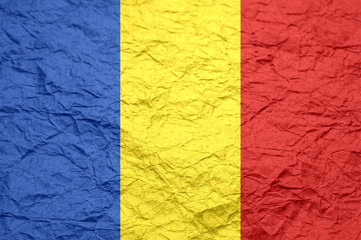 Romania flag on old crumpled craft paper.