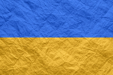 Ukraine flag on old crumpled craft paper.