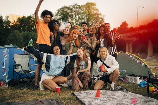 Portrait of happy friends camping during music event